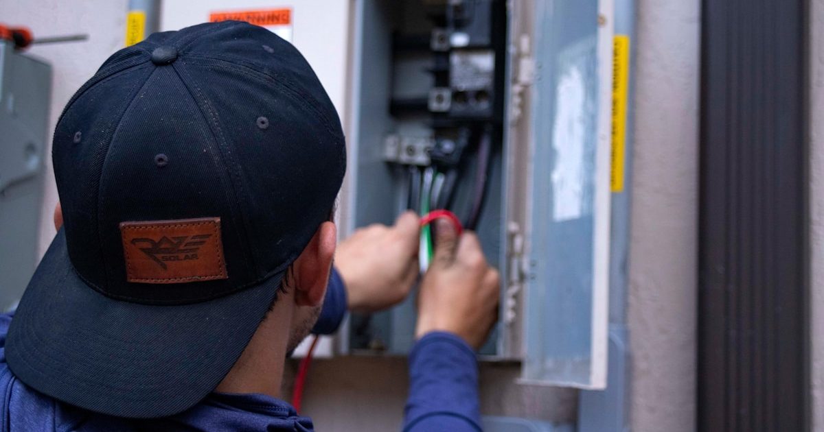 Electrician working in an electrical panel